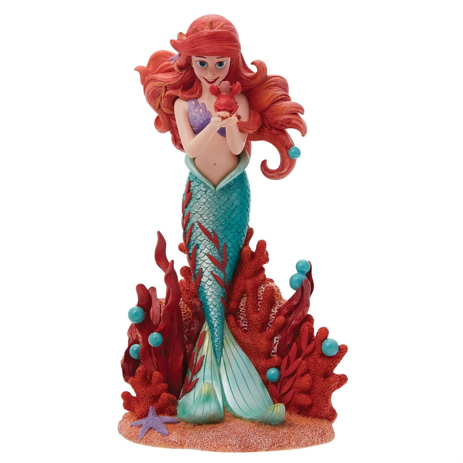 Ariel holds a small Sabastian in her delicate hands.