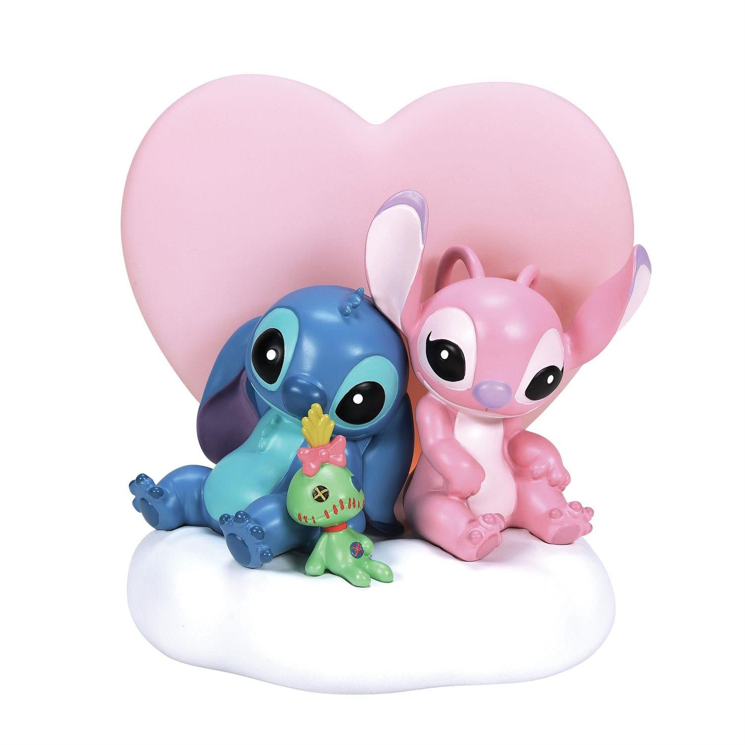 Stitch, Angel and Scrump sit in front of a big pink heart