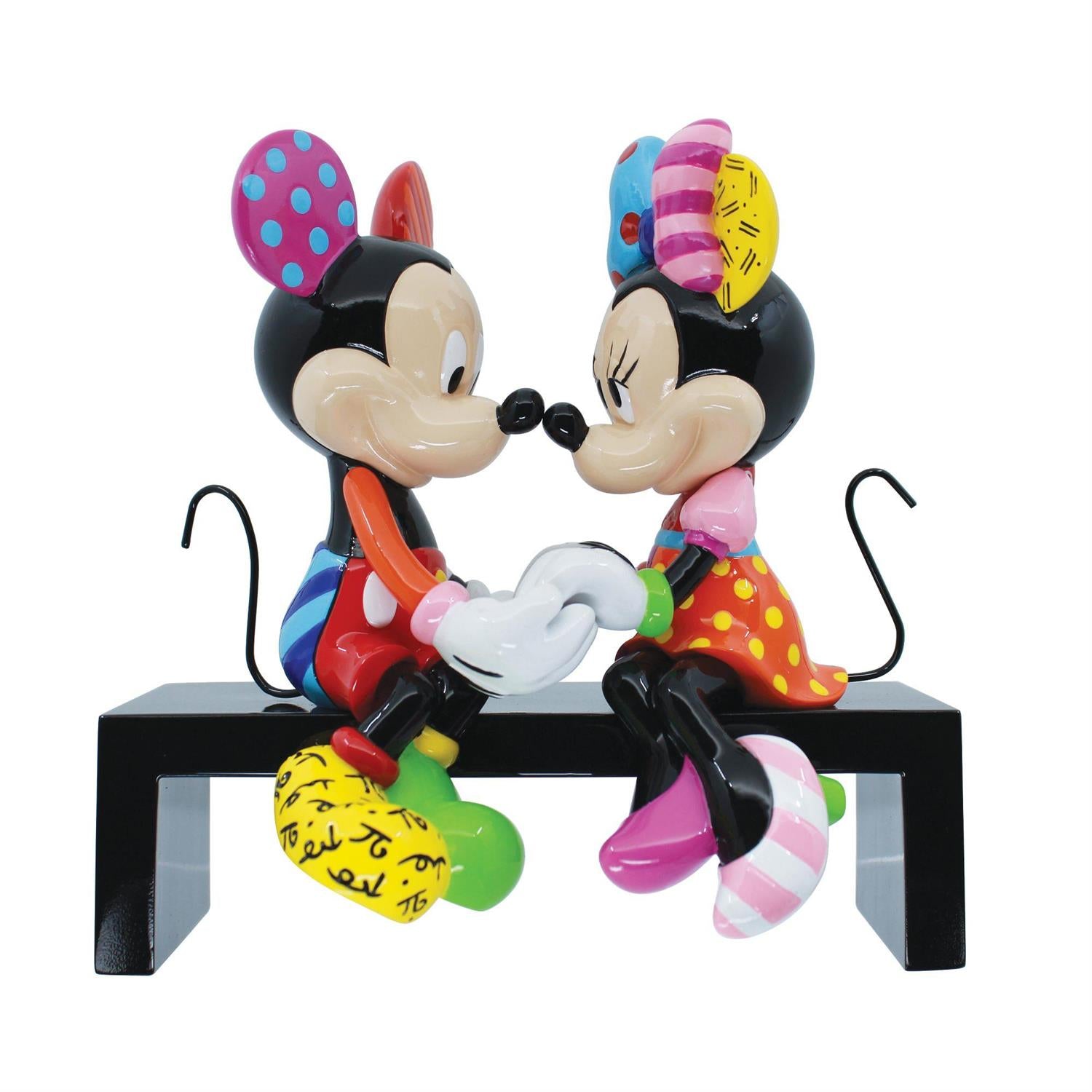 Mickey and Minnie stting on a bench holding hands