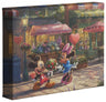 Mickey presents Minnie with a bouquet and a heart-shaped box of chocolate in front of Cafe Bristo. 8x10