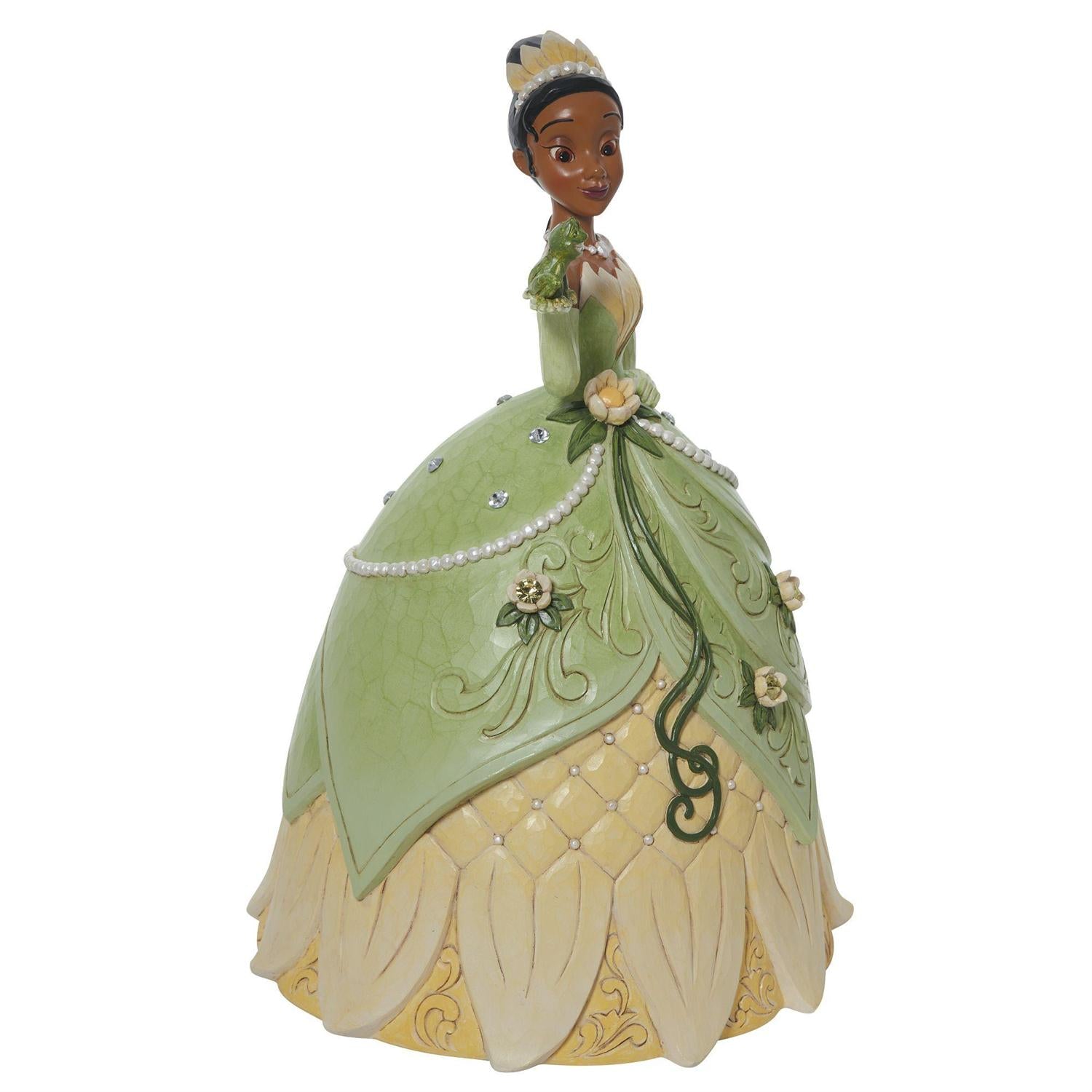 Tiana holds her soon-to-be prince, the frog, in a spectacular floral dress and tiara. - Side view