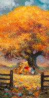 Winnie the Pooh, and friends pose in front of tree filled with autumn colors.