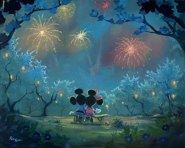 Mickey and Minnie sitting on a bench watching the spectacular firework's celebration lighting-up the night sky.