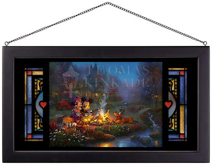 Mickey and Minnie are relaxing on an old log, roasting marshmallows over a crackling campfire.