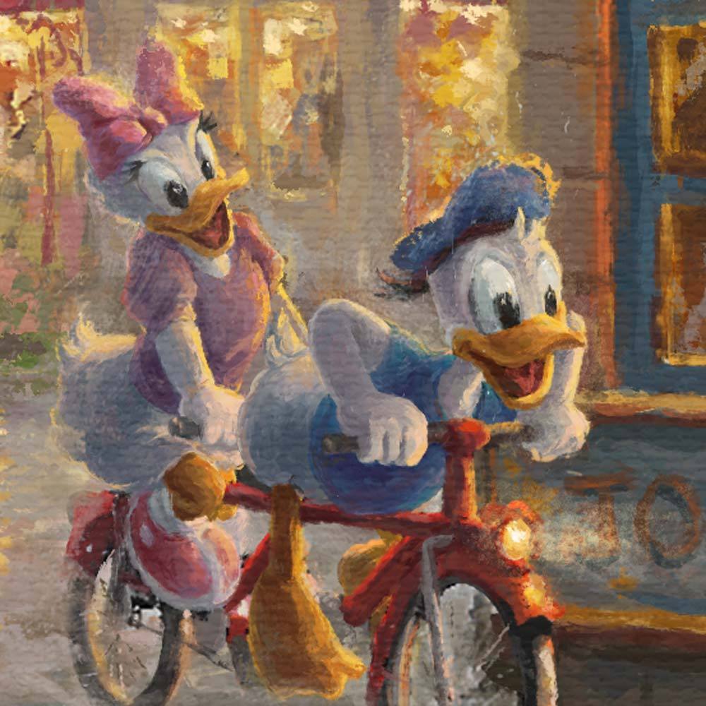 Daisy and Donald, creating quite a splash on their tandem bikes as they ride through the puddle filled streets of Paris - closeup